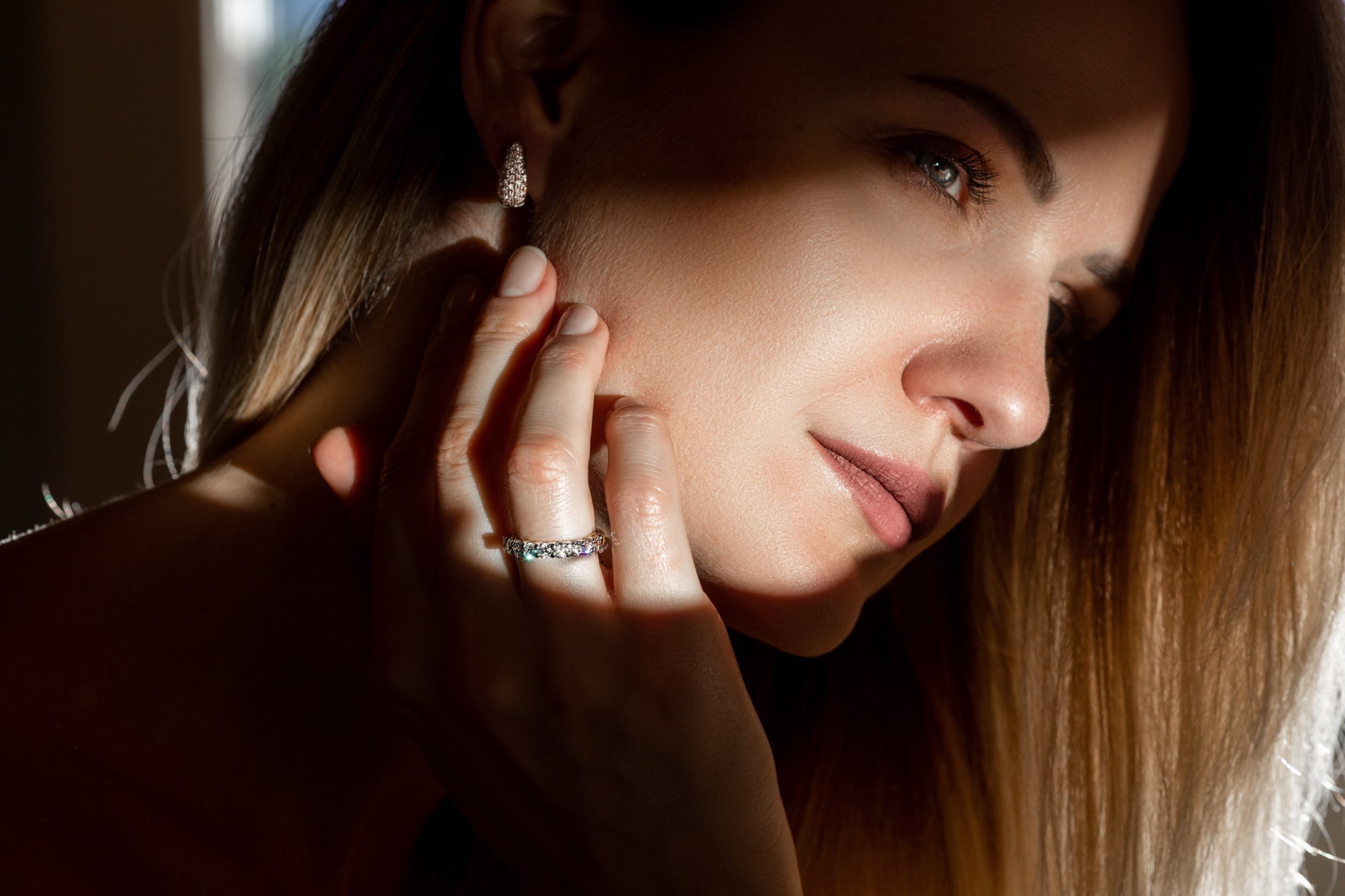 Woman wearing lab-grown diamond ring and earrings from RadiantCarat Holiday Gift Guide